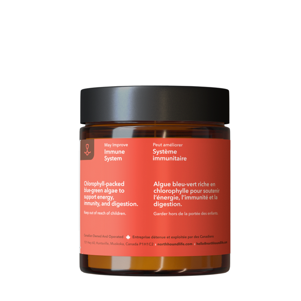 Jar of North Hound Life Spirulina on a white background, in amber glass jar with red immune health label and black plastic cap