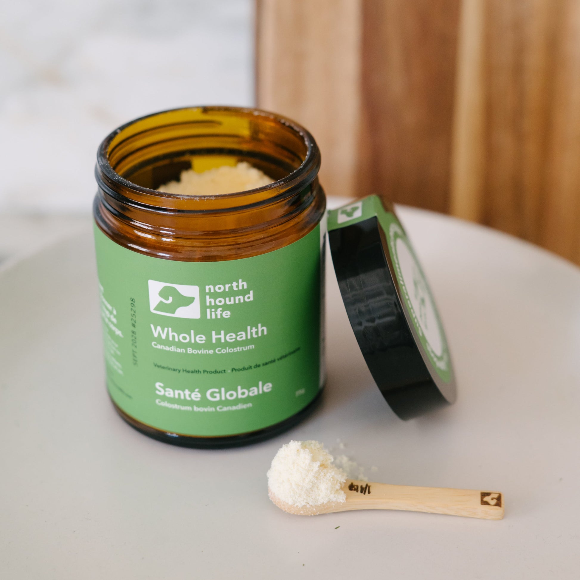 Jar of 'Whole Health' supplement with a spoonful on a white plate